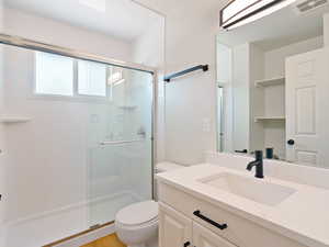 Full bath with a stall shower and vanity