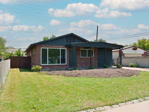 View of front of property with covered porch and brick siding