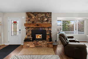 Living room with wood finished floors and a fireplace