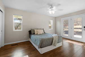 Bedroom featuring access to exterior, hardwood / wood-style floors, and a ceiling fan