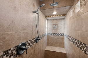 Bathroom featuring a tile shower