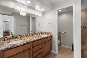 Bathroom with double vanity and tile patterned floors