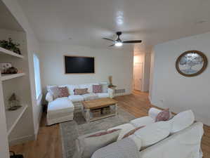 Living area featuring light wood finished floors and ceiling fan