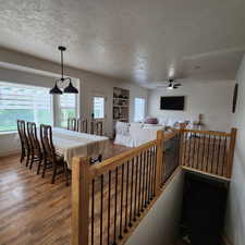 Corridor featuring a textured ceiling and wood finished floors