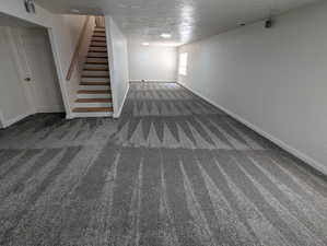 Below grade area with carpet flooring and stairway