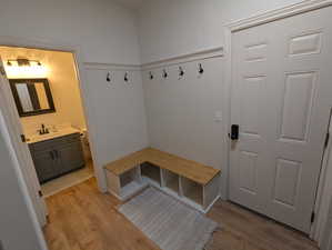 Mudroom with light wood-style floors and wainscoting