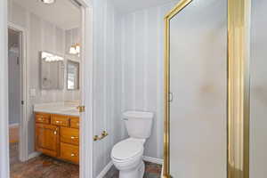 Full bathroom featuring vanity and a stall shower