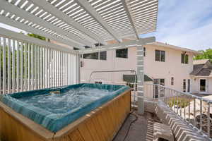 View of patio with a hot tub