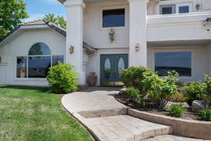 Doorway to property featuring stucco siding and french doors