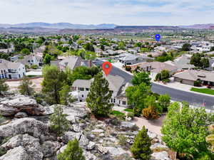 Aerial view of residential area featuring a mountainous background
