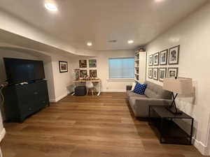 Living room with recessed lighting and wood finished floors