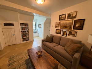 Living area featuring built in shelves and baseboards