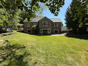 Rear view of house with french doors and stone siding