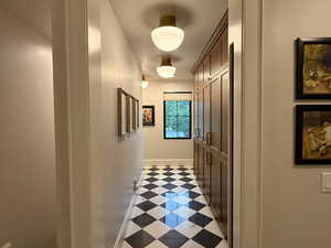 Mudroom with drinking fountain, built-in storage for shoes, coats, and general storage items, and a built-in retractable dog gate.