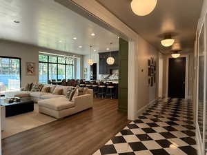 Living area featuring recessed lighting, a chandelier, and wood finished floors