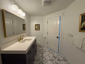 Bathroom featuring vanity and a textured ceiling