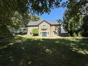 Side of property with french doors and stone siding