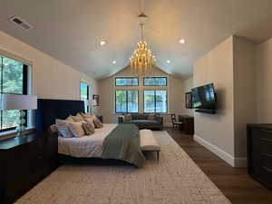Primary Bedroom with dark wood finished floors, recessed lighting, a chandelier, and a vaulted ceiling