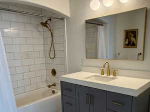 Full bathroom featuring vanity and shower / bath combination with curtain