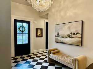 Entryway featuring a chandelier and tile patterned floors