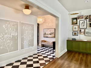 Corridor with tile patterned floors, a chandelier, and recessed lighting