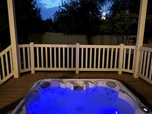 View of spa with a deck and a pergola