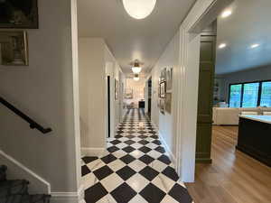 Hallway with recessed lighting and stairs