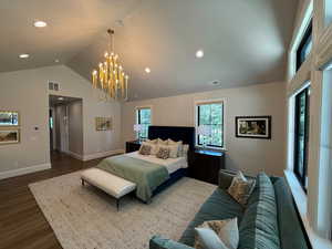 Primary Bedroom with dark wood finished floors, recessed lighting, a chandelier, and a vaulted ceiling