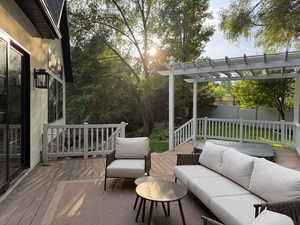 Deck with an outdoor hangout area and a pergola
