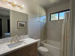 Bathroom featuring vanity and shower / tub combo with curtain