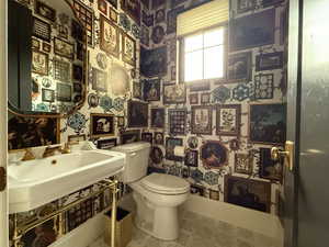 Bathroom with wallpapered walls