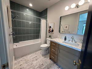 Full bathroom featuring vanity and shower / bathtub combination with curtain