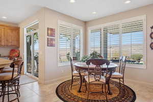 Dining space with recessed lighting and light tile patterned floors