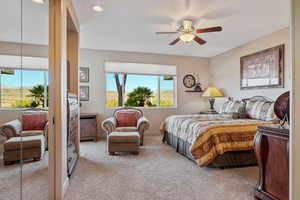 Carpeted bedroom featuring ceiling fan and recessed lighting