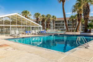 Community pool featuring a patio