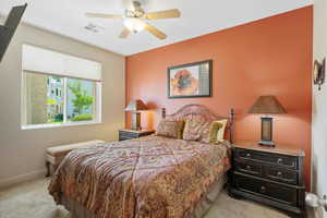 Bedroom with light carpet and ceiling fan
