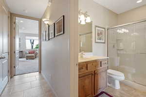 Full bathroom featuring a stall shower, vanity, tile patterned floors, and recessed lighting