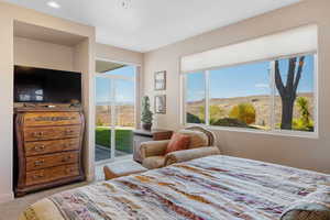 Carpeted bedroom with access to exterior