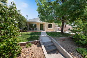 Bungalow-style house with a front lawn and covered porch