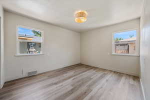 Spare room with light wood-type flooring and baseboards