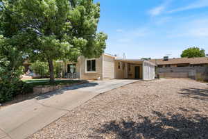 View of front facade featuring driveway and a carport