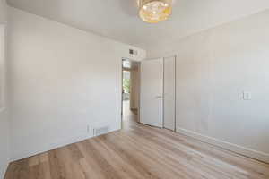 Unfurnished room featuring light wood-style flooring and baseboards