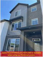 View of side of home with board and batten siding and brick siding