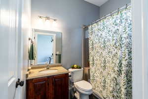 Full bath with vanity and a shower with curtain