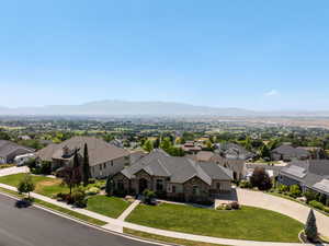 Aerial perspective of suburban area featuring a mountainous background