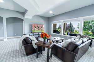 Living room featuring light carpet and arched walkways