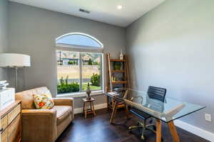 Office space featuring dark wood-type flooring and recessed lighting