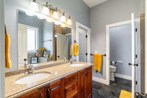 Bathroom with double vanity and toilet