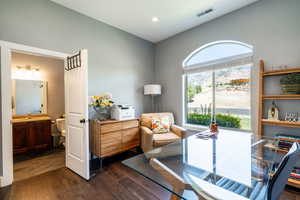 Office space with dark wood finished floors and recessed lighting