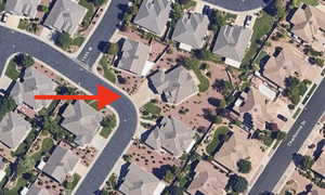 Aerial view of property and surrounding area featuring nearby suburban area